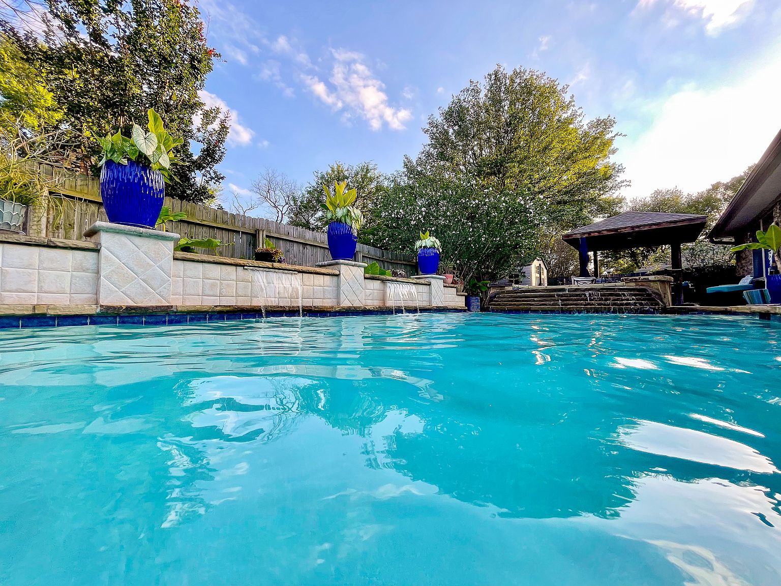 Pool with fountains and stone waterfall